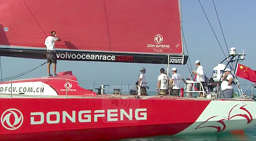 HYC's Dave Cullen positioned under the Chinese national flag as the Dongfeng team wait for the wind to build before the start of the In-Port Race