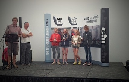 Eve McMahon (in red) collecting her prize as 5th girl overall 