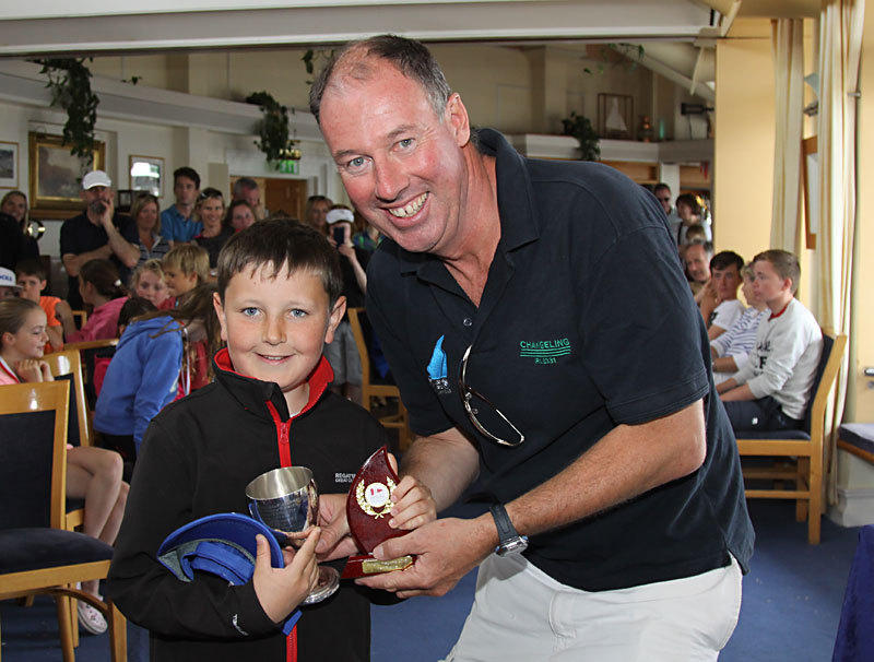 The RStGYC's Trevor Bolger receives the Drisheen Cup for winning the Optimist Main Fleet prize