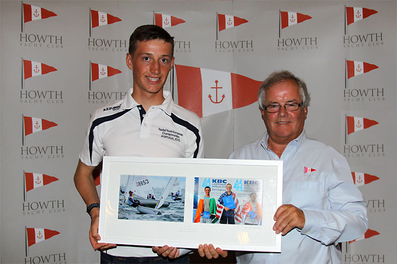 Ewan McMahon is presented with a framed set of photos by Commodore Berchmans Gannon