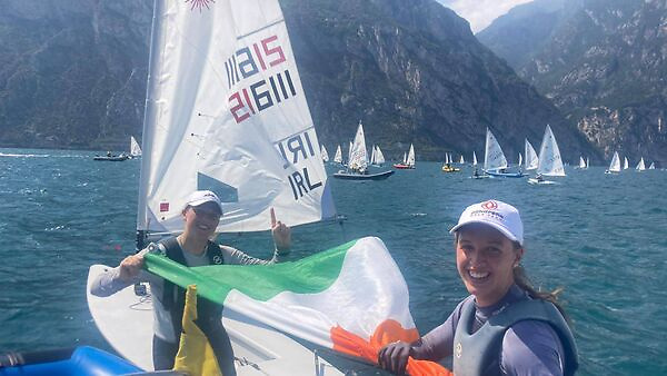 The tension lifts at last…..new champion Eve McMahon (left) celebrates with team mate Ellie Cunnane on Lake Garda. Photo: Vasilij Zbogar