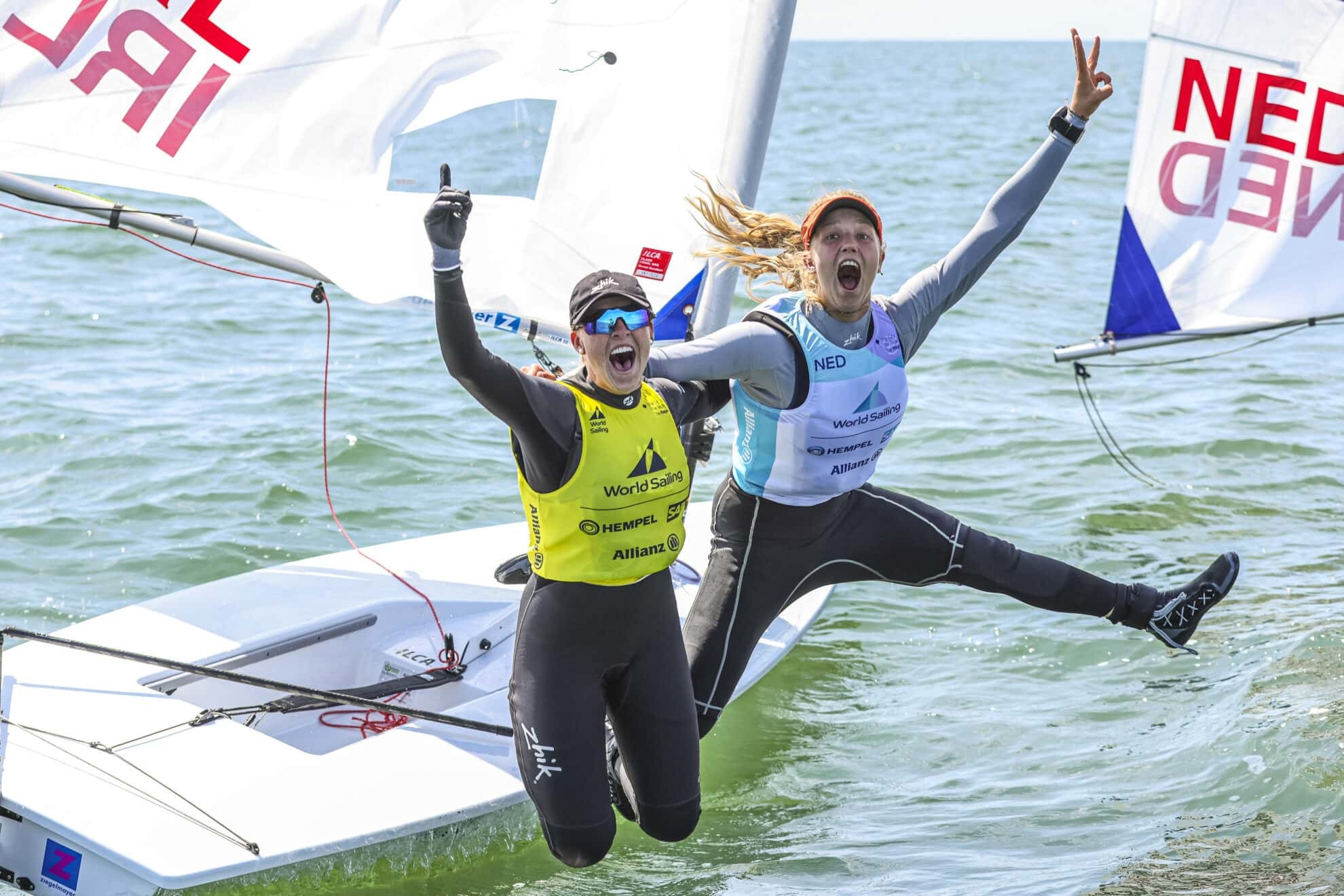 Eve McMahon (left) celebrates her World Sailing Youth Gold in The Hague with rival Roos Wind of the Netherlands Credit: Sailing Energy