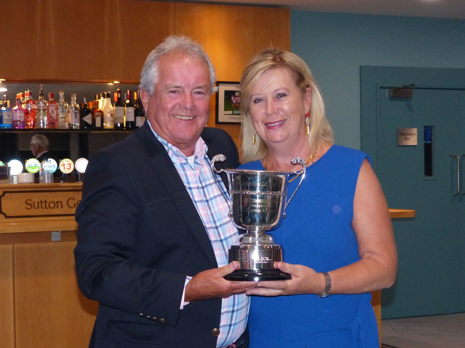 IEGS Captain Berchmans Gannon presenting Golfer of the Year trophy to Mary Fitzpatrick