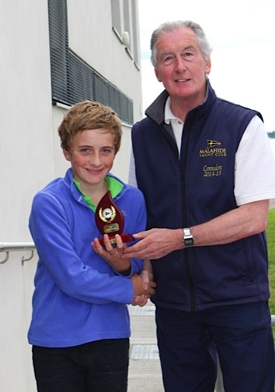 Optimist Gold Fleet 2nd placed William Lacy collects his prize