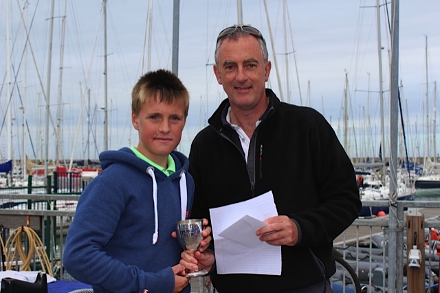Rear Commodore Richard Kissane presents Jamie McMahon with his prize for 1st place in the Optimist Main Fleet